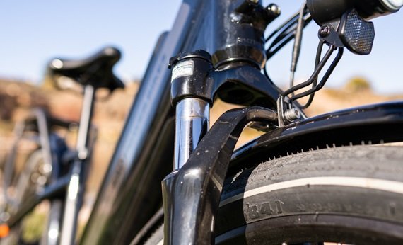 Front suspension fork on the RadCity 5 Plus Step-Thru electric bike absorbing road bumps