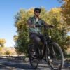 Rider commuting through downtown streets on the RadCity 5 Plus Step-Thru electric bike