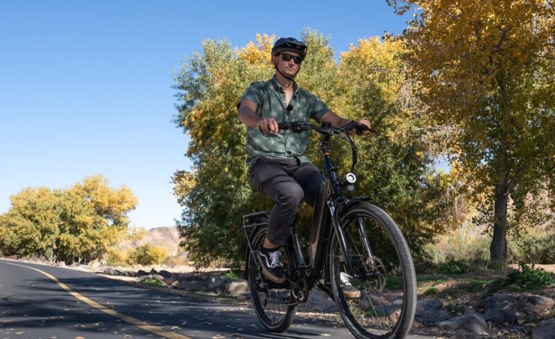 Rider commuting through downtown streets on the RadCity 5 Plus Step-Thru electric bike