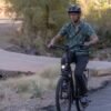 RadCity 5 Plus Step-Thru electric commuter bike riding along a beautiful urban boulevard