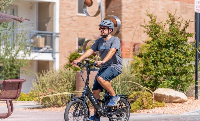Lectric ONE electric commuter bike riding through an urban park