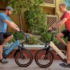 Lectric XPedition 2.0 electric cargo bike riding through downtown streets
