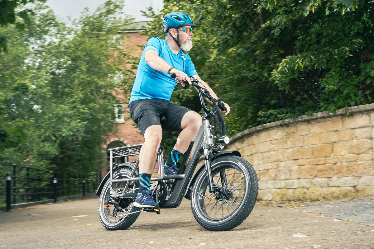 RadRunner 3 Plus utility electric bike leaning confidently through a city corner