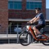 RadCity 5 Plus Step-Thru electric bike riding through busy downtown streets
