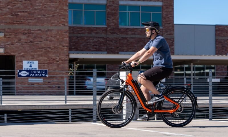 RadCity 5 Plus Step-Thru electric bike riding through busy downtown streets