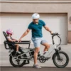 Father riding the Lectric XPedition 2.0 cargo electric bike with his child safely seated on the rear passenger seat