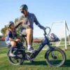 Father carrying his son on an Aventon Sinch.2.5 folding electric bike during a family ride
