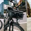 RadCity 5 Plus electric commuter bike cruising through busy downtown city streets