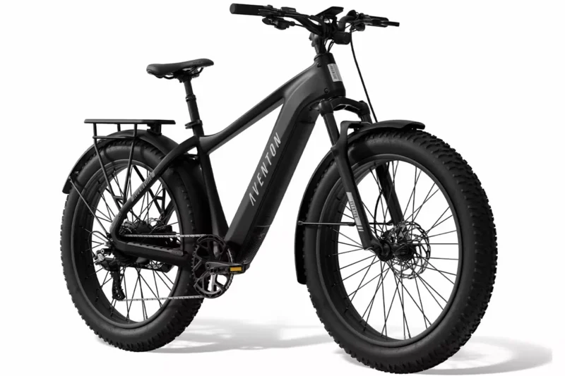 Aventon Aventure.3 Stealth electric bike riding off-road through rugged terrain