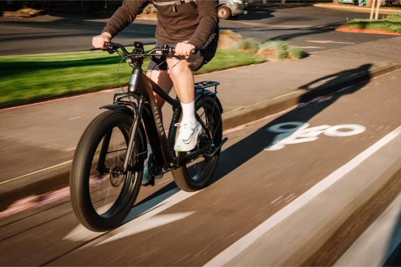 Modern commuter electric bike riding through a city street.