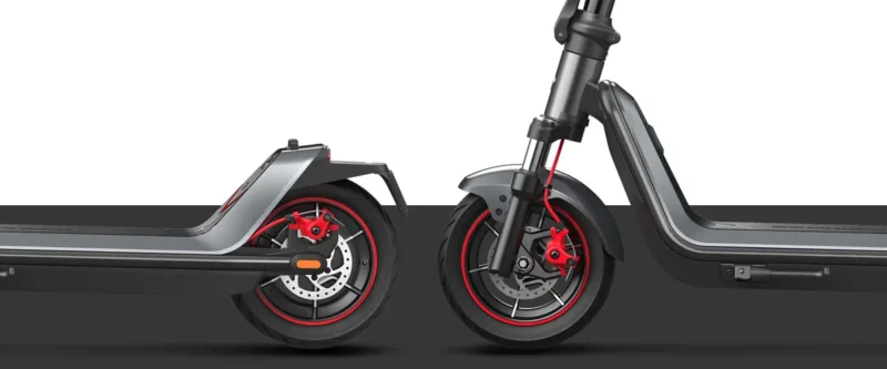 Side-by-side studio view of the front and rear wheels of an electric scooter highlighting the dual disc brakes.