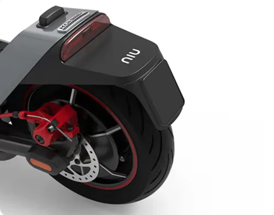 Close-up of an electric scooter's rear fender, tail light, and red disc brake caliper.