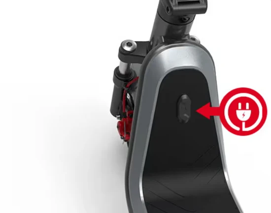 Close-up of an electric scooter deck showing the charging port with a red charging icon graphic next to it.