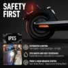 A close-up of the rear wheel and taillight assembly of the dark gray NIU KQi 200P electric scooter against a dark background. The red taillight is illuminated. Text in the top left reads "SAFETY FIRST". Below this, an inset graphic shows an IPX5 water resistance logo and a rider using the bright headlight. Further text details integrated lighting, IPX5 rating, and the front drum/rear regenerative braking system.