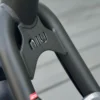 Close-up of the reinforced black metal steering fork junction featuring the embossed NIU brand logo